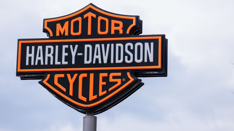 The sign of the US motorcycle manufacturer Harley Davidson is in front of the Harley Davidson Store